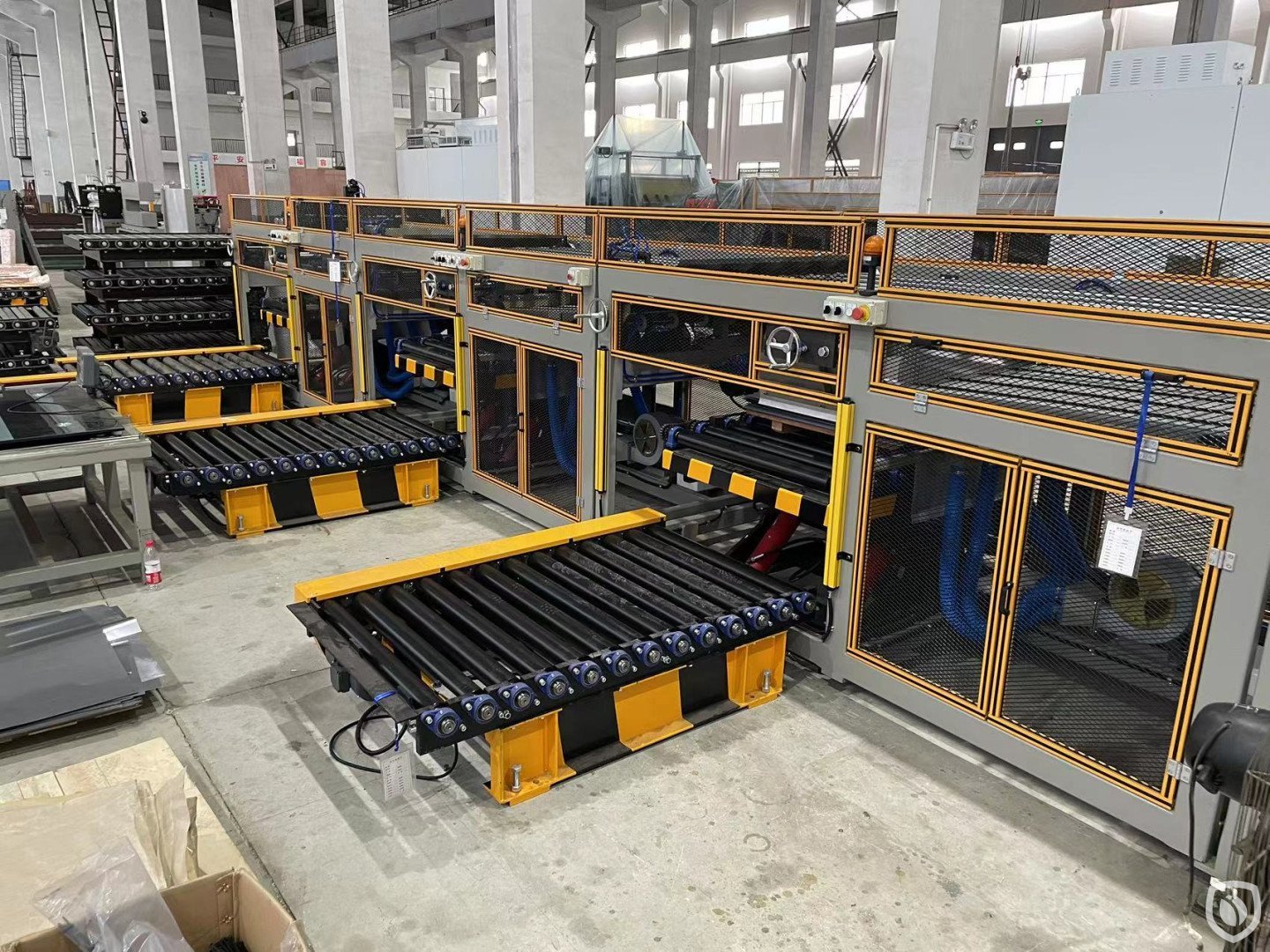 Three (3) stackers, roll conveyor